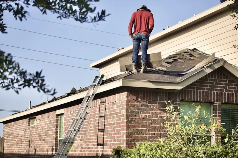 Professional roofer working on a residential roof in Old Town District